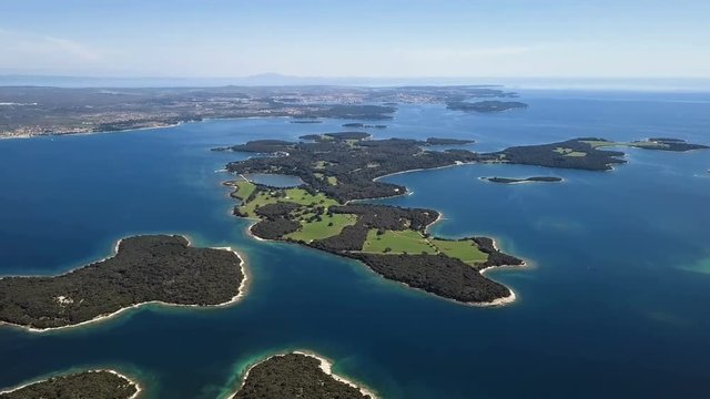 Flight over desert islands and colorful sea, Brijuni park, Croatia