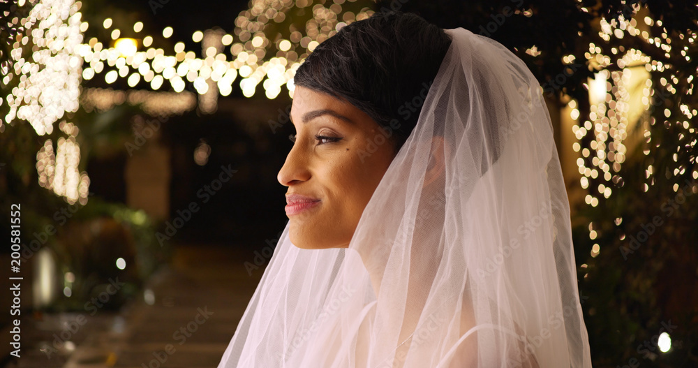 Wall mural profile of lovely bride in wedding veil standing outside romantic venue at night - Wall murals
