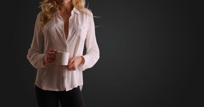 Portrait Of Caucasian Woman In Button Down Holding Coffee Mug On Grey Background