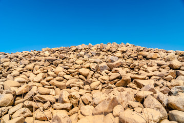 grey wall of round stones.