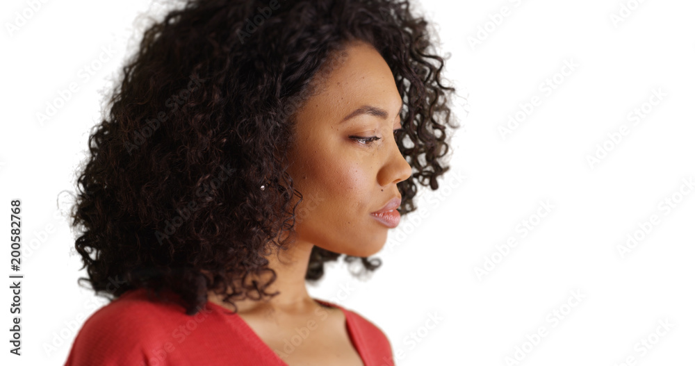 Poster Young African female thinking deeply by herself on white background