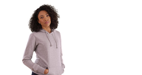 Casual black female wearing gray hoodie posing for camera on white copy space