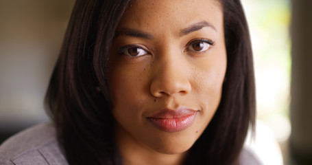 Obraz premium Tight shot of casual millennial African young lady's face in indoor setting