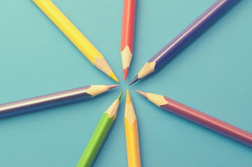 Naklejka premium Colorful ground pencils group on a blue background.