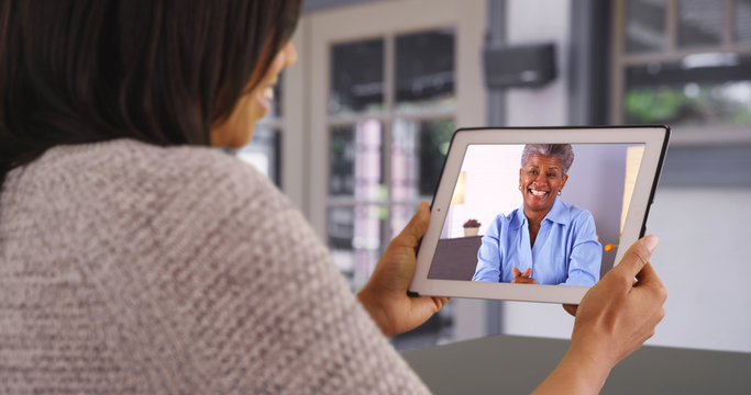 Mother And Daughter Spending Quality Time Together Video Chatting