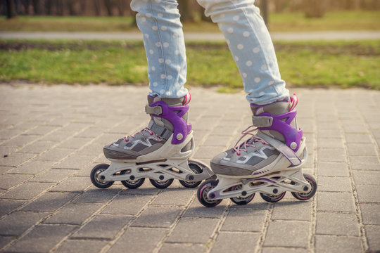 Girl on roller skates in the Park.
