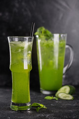 Homemade flavored lemonade with a glass on a dark background