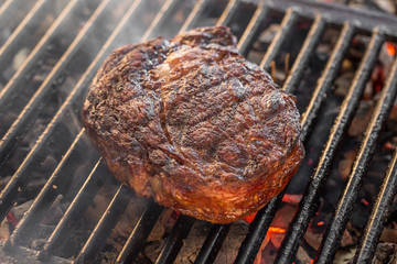 Big marbled Beef steak on the grill with flames