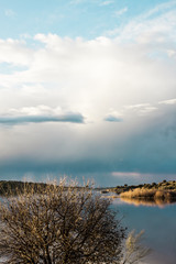 landscape with clouds and reflections in the river
