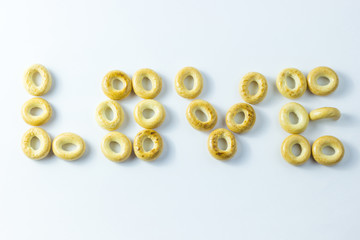 A word of love made from small rolls on a white background.