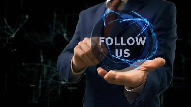 Businessman shows concept hologram Follow us on his hand. Man in business suit with future technology screen and modern cosmic background