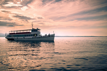 Ferry on Lake Garda at sunset.