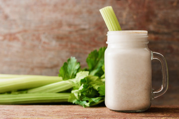 Smoothies of oatmeal and celery on wooden background