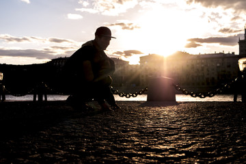 happy man success on a sunset dancing in the city