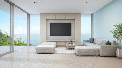 Sea view living room of luxury beach house with glass door and wooden terrace. Large white sofa against blue wall near TV in vacation home or holiday villa for big family. Hotel interior 3d rendering.