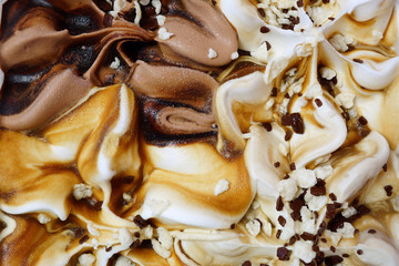 Ice cream close-up. A mixture of chocolate, caramel and vanilla ice cream. Abstract background.