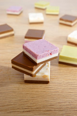 Chocolate candies. Square chocolate with fruit and nut filling. Shallow depth of field.