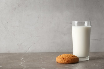 Glass of milk with oatmeal cookie on table. Fresh dairy product