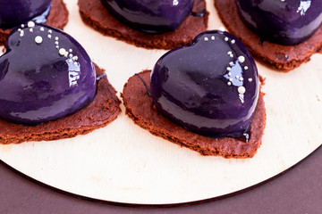 Blue mirror glaze heart cakes dessert on Valentines Day.