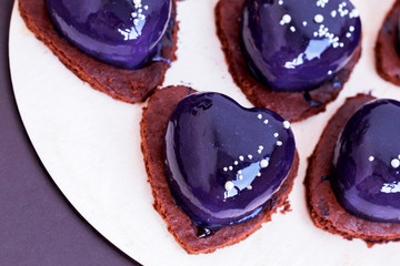 Blue mirror glaze heart cakes dessert on Valentines Day.