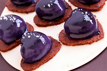 Blue mirror glaze heart cakes dessert on Valentines Day, modern dessert.