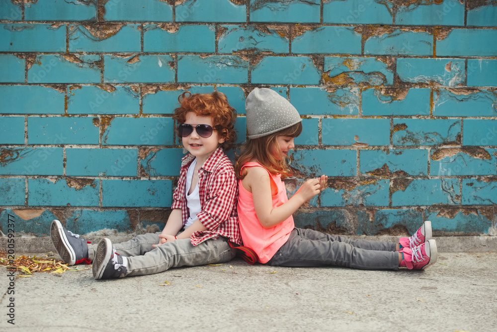 Wall mural hipster boy and girl in park