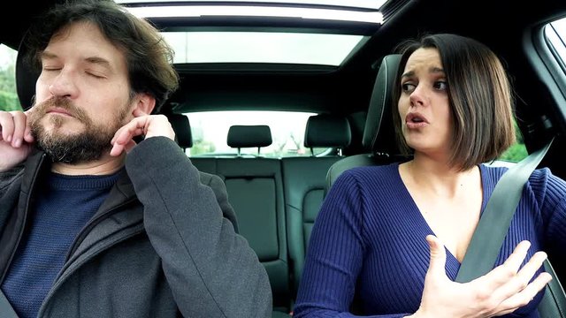 Wife angry with husband not willing to listen covering ears