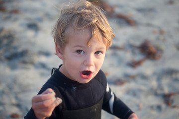 Boy Playing At Beach In Wetsuit
