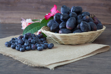Blueberry and black grape on wooden table