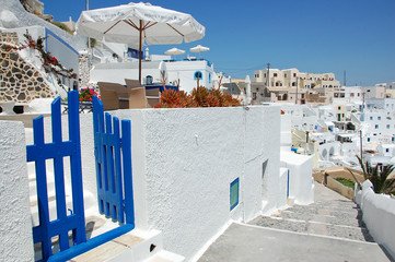 Greece Santorini island, traditional sights of colorful and white washed houses with wooden frames and flowers