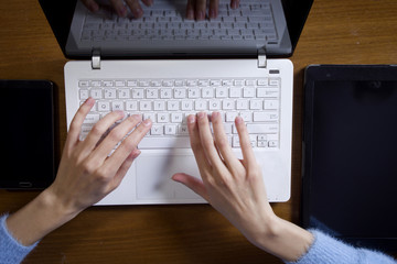Fototapeta premium Female hands are working on a laptop computer