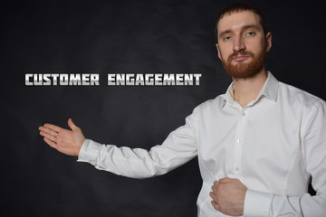 A businessman shows an inscription:CUSTOMER ENGAGEMENT