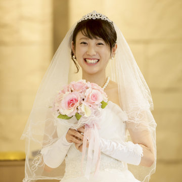 教会でブーケを持ち微笑む花嫁