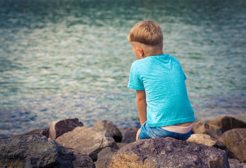Fototapeta na wymiar Cute caucasian boy at seaside