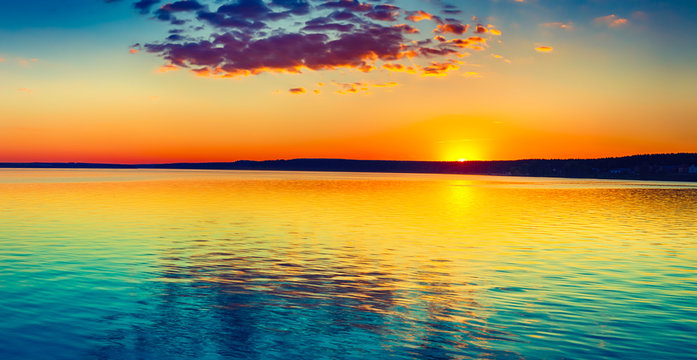 Sunset over the lake. Amazing panorama landscape