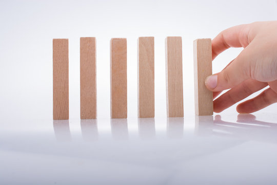 Hand holding wooden domino