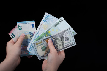 Hand holding American dollar  isolated on black background