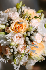 wedding rings with bouquet