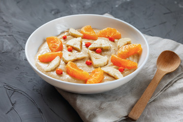 Detox smoothies with flax seed, banana, tangerine, sea buckthorn berries close-up. The concept of a healthy diet