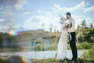 Happy couple in love having fun outdoors with party set mask.