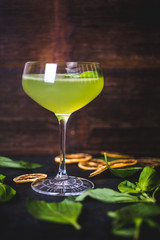 Green cocktail on the background of a wooden background.