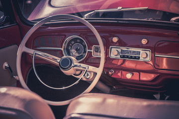 Close-up, detailed photo of the interior, dashboard, steering wheel and speedometer of a classic...