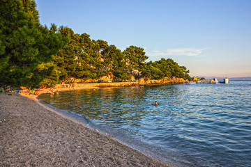 Tourists on Croatian resort Makarska sea beach.