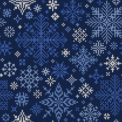 Seamless knitted pattern of blue and white snowflakes