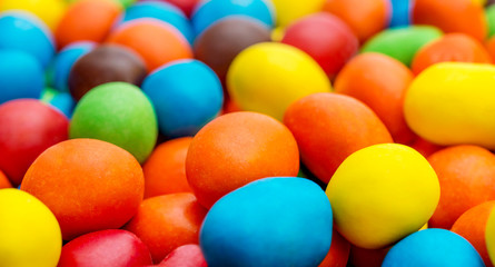 Sweet round multi colored candies. Close up. Abstract and food background.