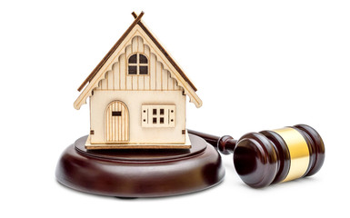 Model of house with judge's gavel and stand on white. Real estate law. Real estate auction concept.