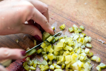 Hands chop the salad