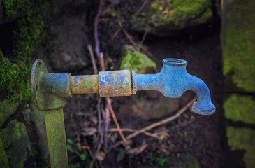 Old rusty water faucet in the garden