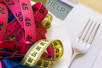 scales and metric tapes with steel cutlery. diet and slimming concept