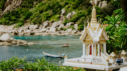 Buddhist spirit house shrine stands on Tanote Bay with Beautiffull Coral Reef, Koh Tao, Thailand © Igor Tichonow